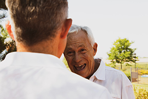 older man smiling along with his friend