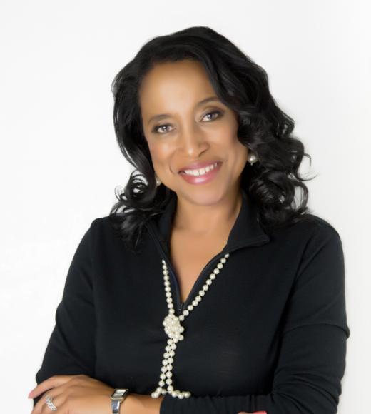 Gayle smiling at camera, arms crossed.