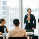 Woman sharing at business meeting. 